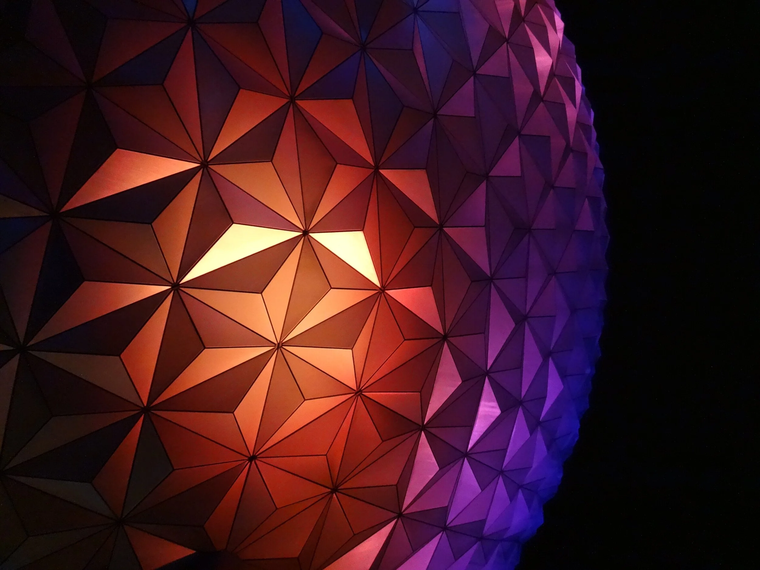 Geometric pattern with colorful lighting on a spherical structure